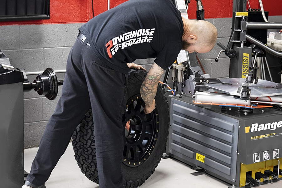 Car wheels being professionally balanced with a wheel balancer to ensure a smooth ride, prevent vibrations, and protect tires and suspension.